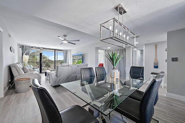 dining room with ceiling fan, a textured ceiling, and light wood-type flooring