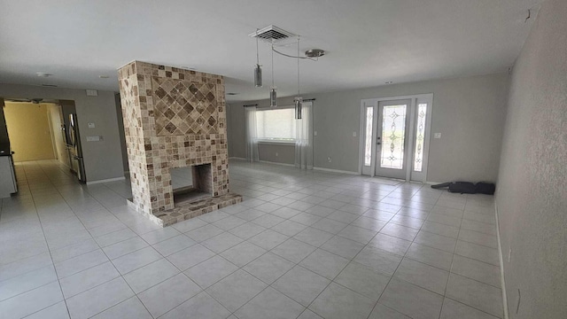 unfurnished living room featuring light tile patterned floors and a fireplace