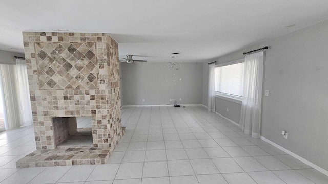 unfurnished living room featuring a brick fireplace, ceiling fan, and light tile patterned flooring