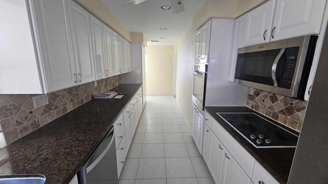 kitchen featuring white cabinetry, light tile patterned floors, tasteful backsplash, and appliances with stainless steel finishes