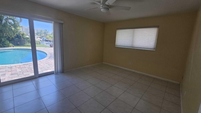 tiled empty room with ceiling fan