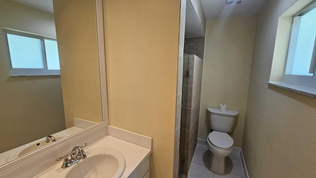 bathroom with tile patterned flooring, a shower, vanity, and toilet