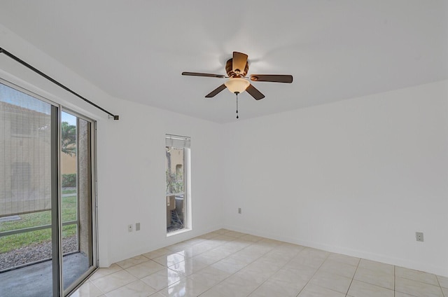 tiled spare room with ceiling fan