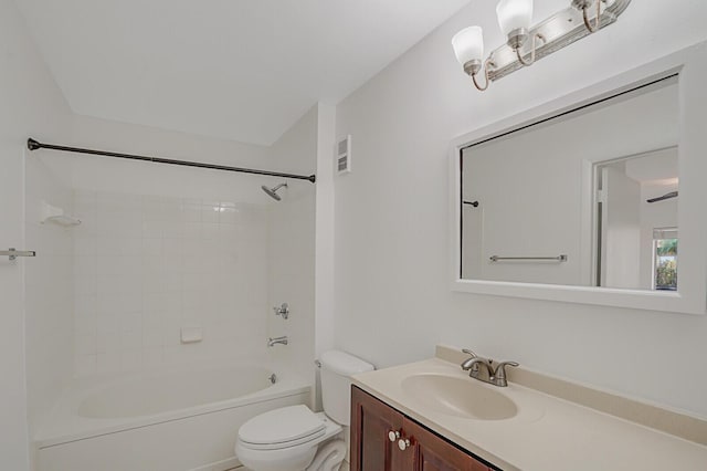 full bathroom featuring vanity, tiled shower / bath, and toilet