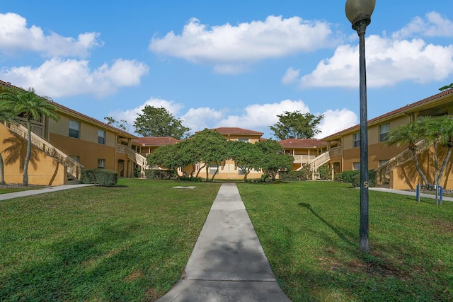 view of home's community with a yard