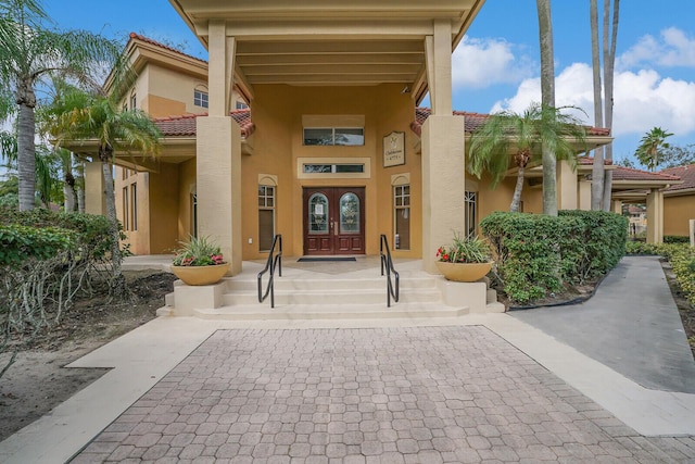 view of exterior entry featuring french doors