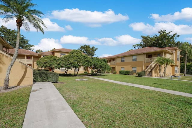 view of home's community featuring a lawn