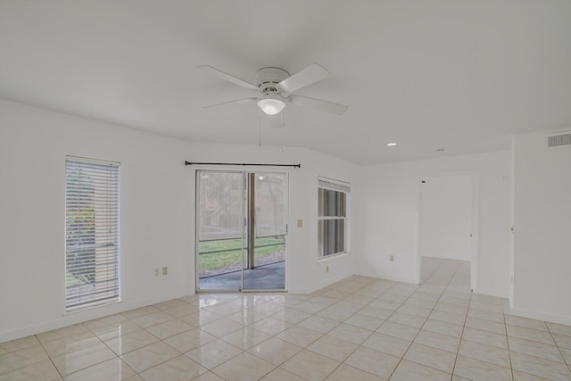 spare room featuring light tile patterned flooring and ceiling fan