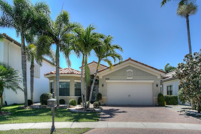 mediterranean / spanish house with a garage