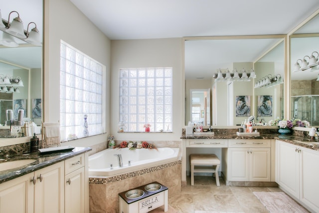 bathroom featuring vanity and separate shower and tub