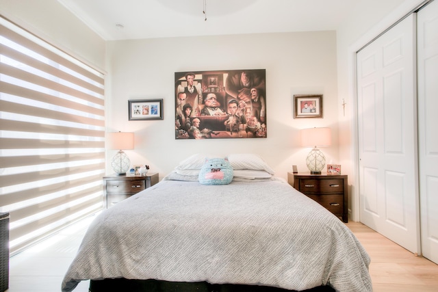 bedroom featuring light wood-type flooring and a closet