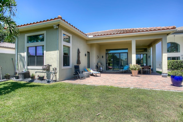 rear view of property with a yard, a patio area, and central air condition unit