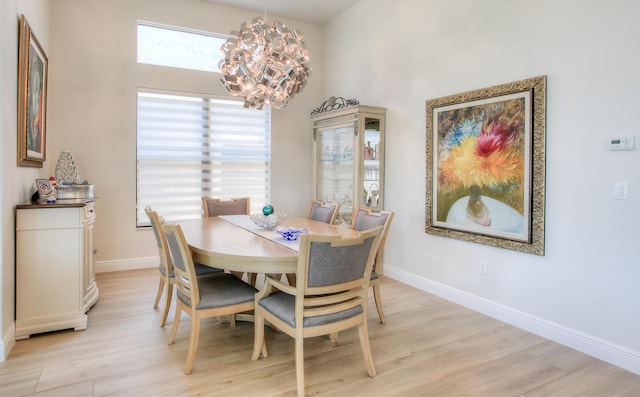 dining room with a chandelier and light hardwood / wood-style flooring