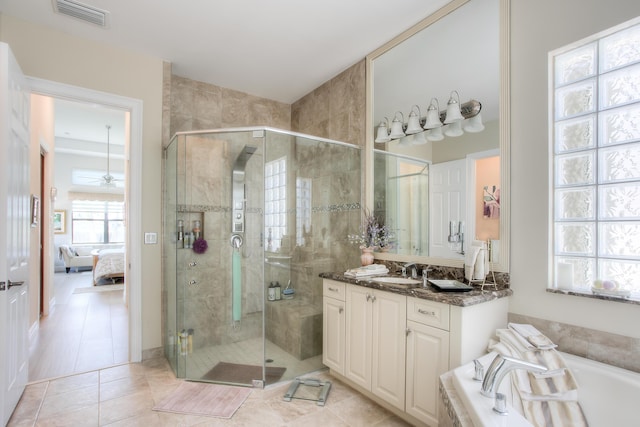 bathroom with vanity, tile patterned floors, ceiling fan, and plus walk in shower