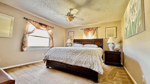 carpeted bedroom featuring a ceiling fan, a textured ceiling, and baseboards