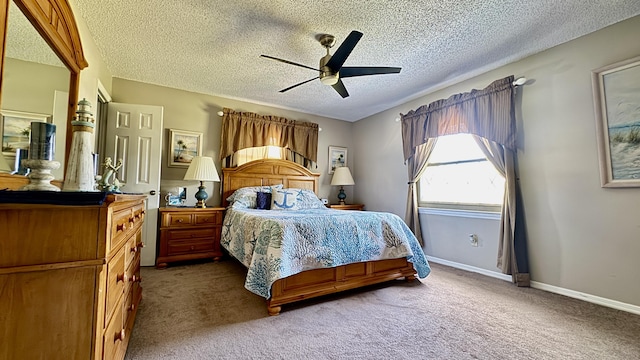 carpeted bedroom featuring a textured ceiling, baseboards, and a ceiling fan