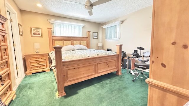 bedroom featuring multiple windows, a ceiling fan, dark colored carpet, and a textured ceiling