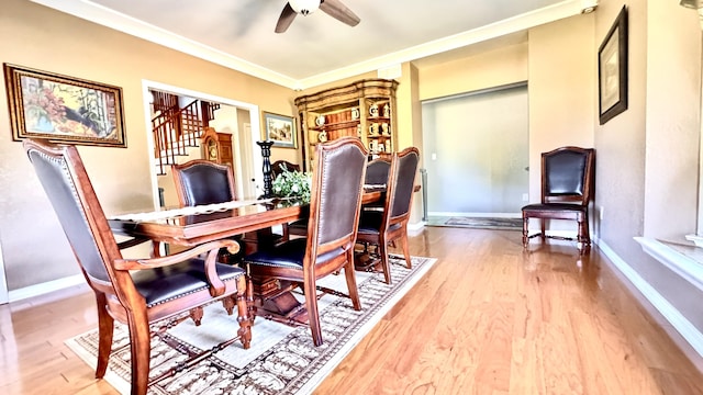 office featuring ornamental molding, ceiling fan, baseboards, and wood finished floors