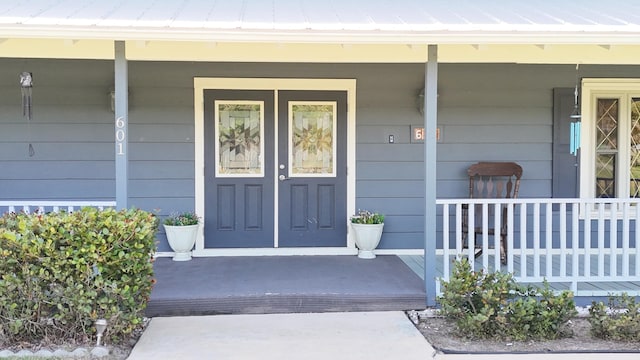 doorway to property featuring a porch