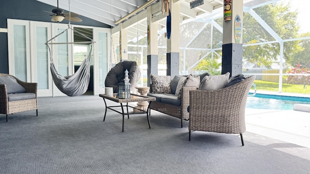 sunroom featuring vaulted ceiling and ceiling fan