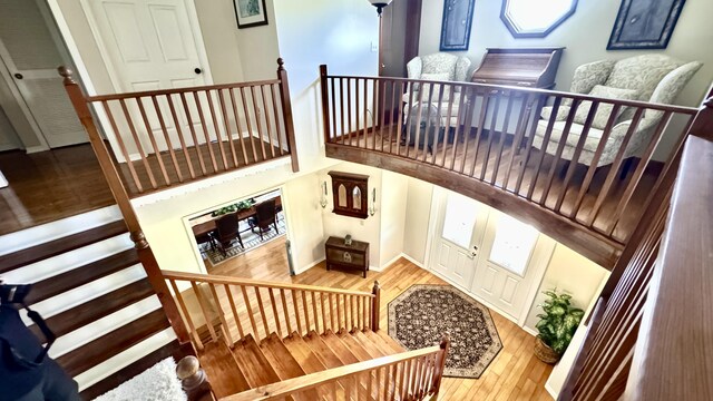 interior space with a textured ceiling and an upstairs landing