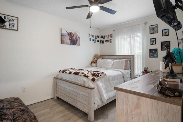 bedroom featuring hardwood / wood-style floors and ceiling fan