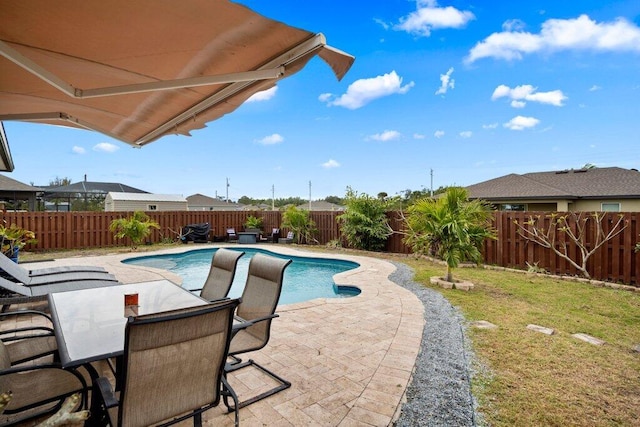 view of pool featuring a yard and a patio area