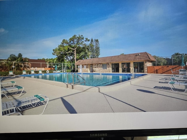 view of swimming pool with a patio area