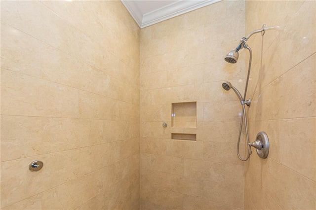 bathroom with a tile shower and crown molding