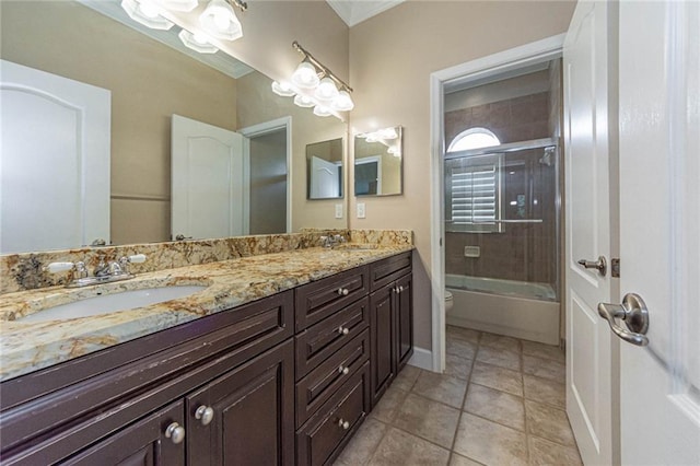 full bathroom with tile patterned flooring, vanity, combined bath / shower with glass door, and toilet