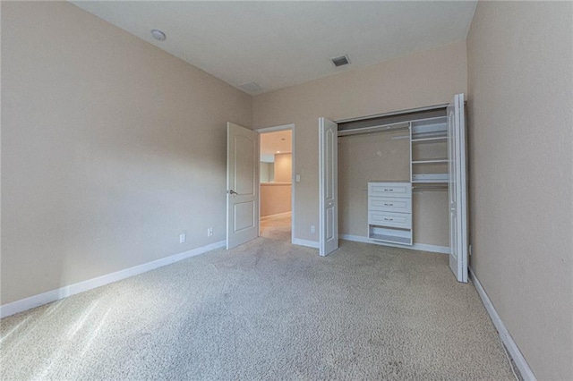 unfurnished bedroom featuring carpet flooring and a closet