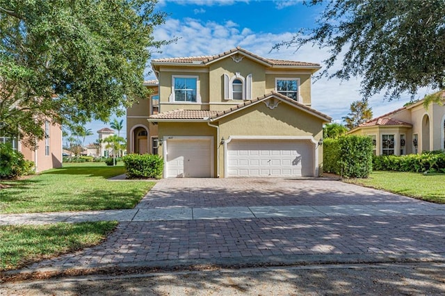 mediterranean / spanish house featuring a garage and a front lawn