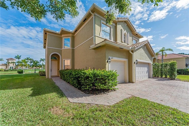 view of front of property featuring a garage and a front lawn