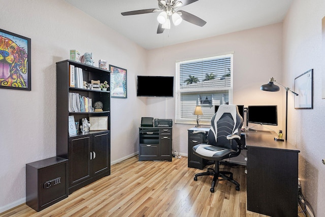 home office featuring ceiling fan and light hardwood / wood-style flooring