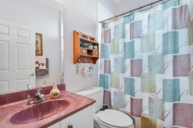 bathroom featuring vanity, curtained shower, and toilet