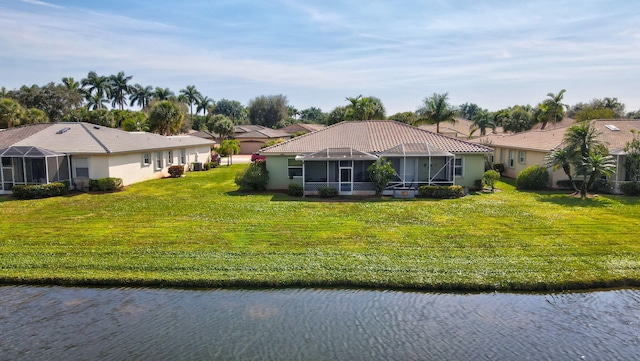 exterior space featuring a lanai, a front yard, and a water view