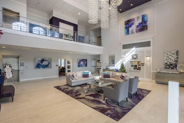 living room featuring an inviting chandelier and a high ceiling