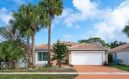 mediterranean / spanish home with a garage