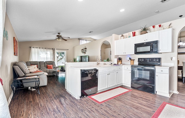 kitchen with lofted ceiling, dark hardwood / wood-style floors, black appliances, white cabinets, and kitchen peninsula