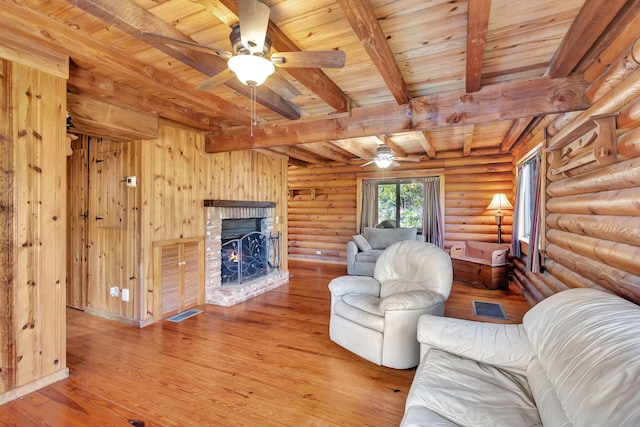 unfurnished living room with light hardwood / wood-style flooring, ceiling fan, beam ceiling, log walls, and wooden ceiling