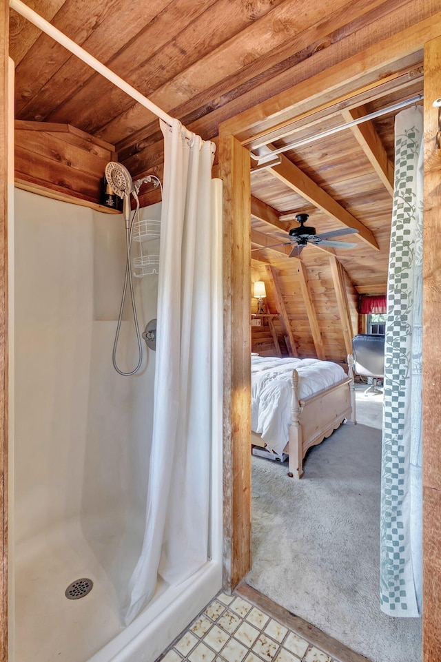 bathroom with ceiling fan, a shower with shower curtain, wood ceiling, and wood walls