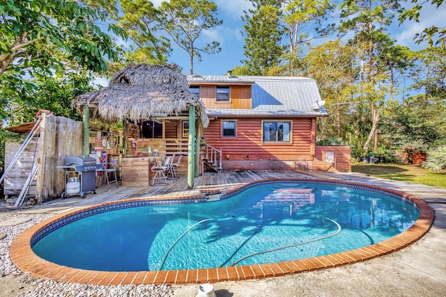 view of swimming pool with an outdoor bar and grilling area