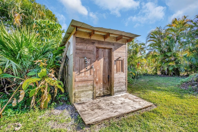 view of outbuilding with a lawn