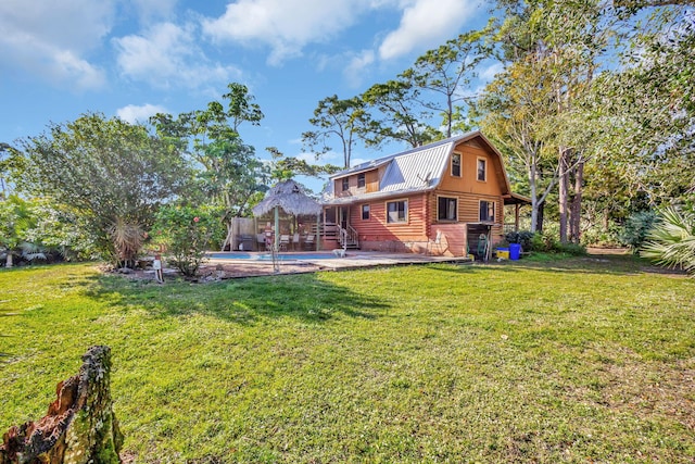 rear view of property with a lawn