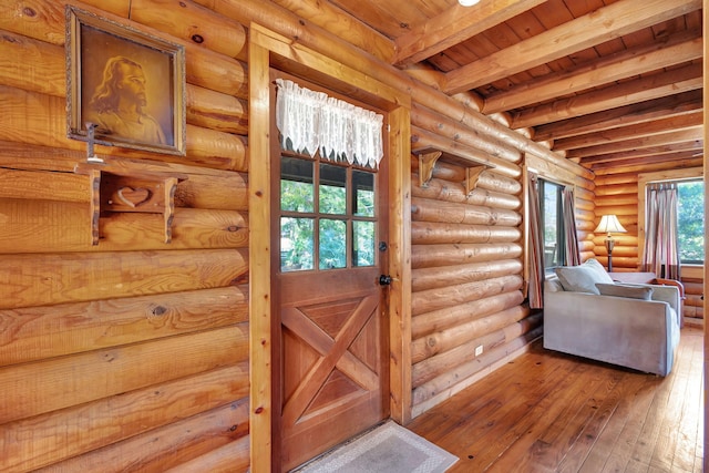 entryway featuring beamed ceiling, hardwood / wood-style flooring, wooden ceiling, and log walls