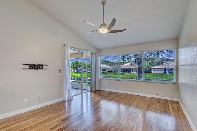 unfurnished room featuring lofted ceiling, wood-type flooring, and ceiling fan