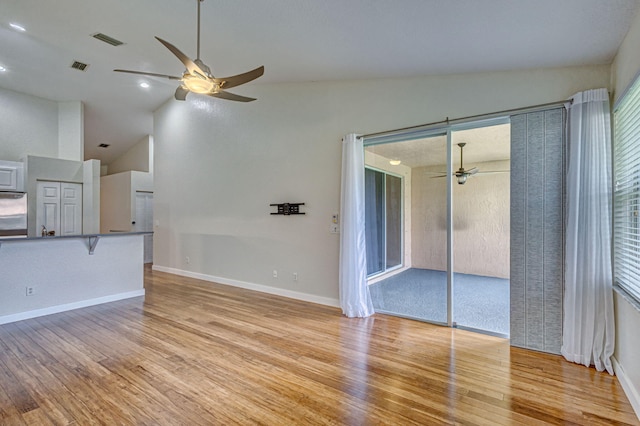 unfurnished living room featuring ceiling fan, high vaulted ceiling, and light hardwood / wood-style floors