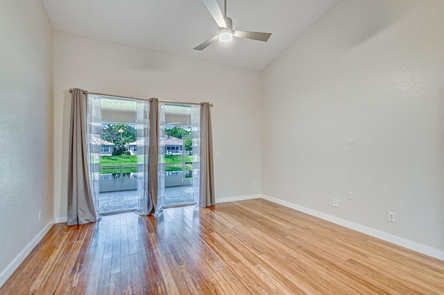 unfurnished room featuring wood-type flooring, ceiling fan, and vaulted ceiling