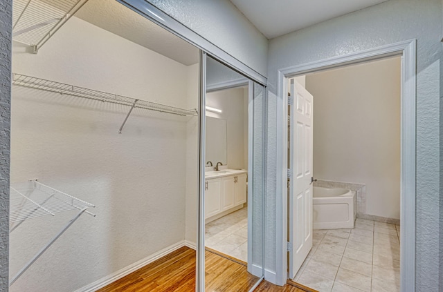 bathroom with vanity, a bath, and hardwood / wood-style floors