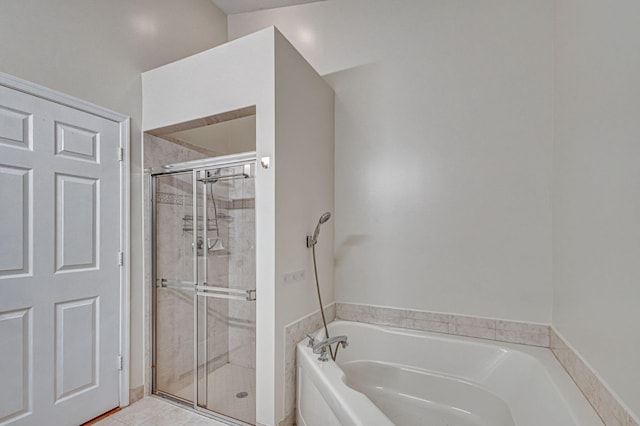 bathroom featuring tile patterned flooring and plus walk in shower